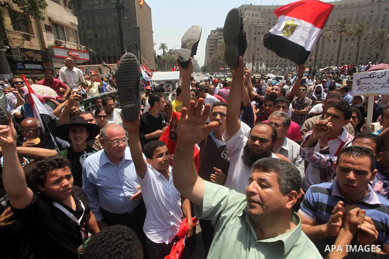 Egyptian protesters hold shoes and shout slogans against the presidential candidate Ahmed Shafik, during a protest in Tahrir Square, Cairo, Egypt, 01 June 2012. Media reports state that hundreds of Egyptians held a demon...