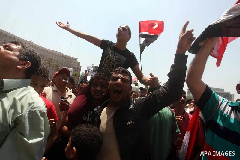 Egyptian protesters hold placards and shout slogans against the presidential candidate Ahmed Shafik, during a protest in Tahrir Square, Cairo, Egypt, 01 June 2012. Media reports state that hundreds of Egyptians held a de...