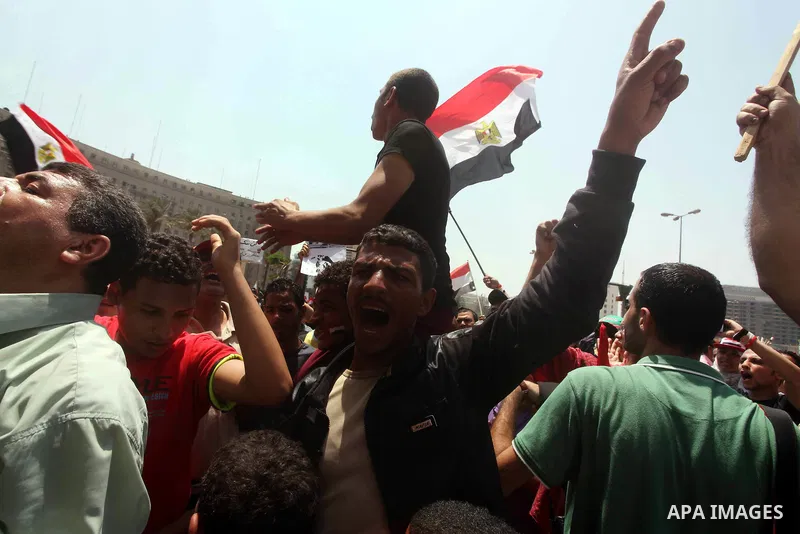 Egyptian protesters hold placards and shout slogans against the presidential candidate Ahmed Shafik, during a protest in Tahrir Square, Cairo, Egypt, 01 June 2012. Media reports state that hundreds of Egyptians held a de...