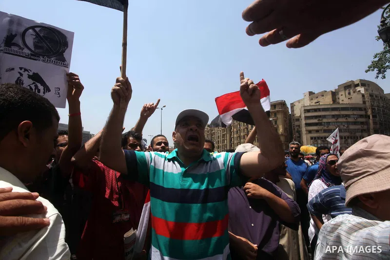 Egyptian protesters hold placards and shout slogans against the presidential candidate Ahmed Shafik, during a protest in Tahrir Square, Cairo, Egypt, 01 June 2012. Media reports state that hundreds of Egyptians held a de...