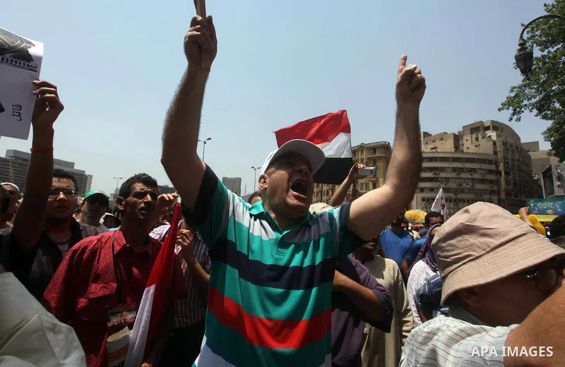 Egyptian protesters hold placards and shout slogans against the presidential candidate Ahmed Shafik, during a protest in Tahrir Square, Cairo, Egypt, 01 June 2012. Media reports state that hundreds of Egyptians held a de...