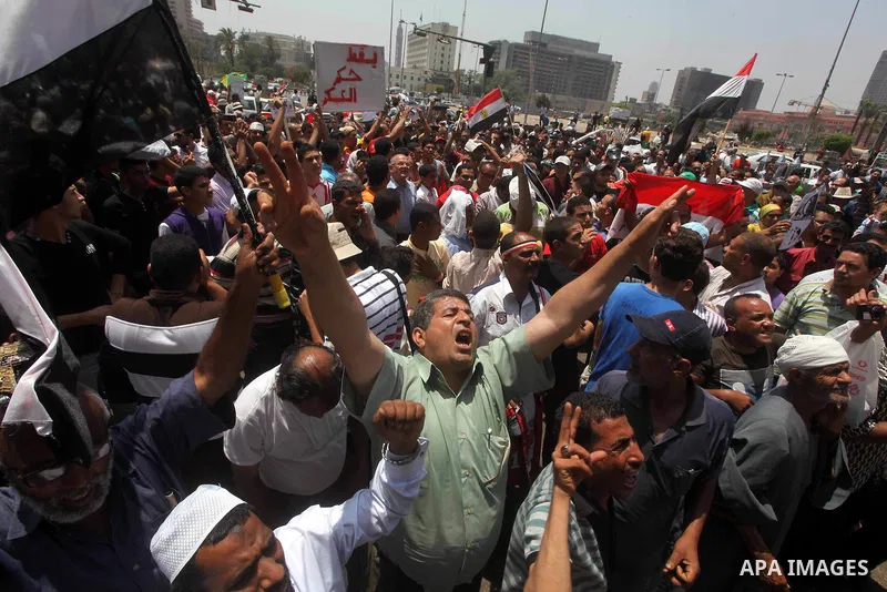 Egyptian protesters hold placards and shout slogans against the presidential candidate Ahmed Shafik, during a protest in Tahrir Square, Cairo, Egypt, 01 June 2012. Media reports state that hundreds of Egyptians held a de...