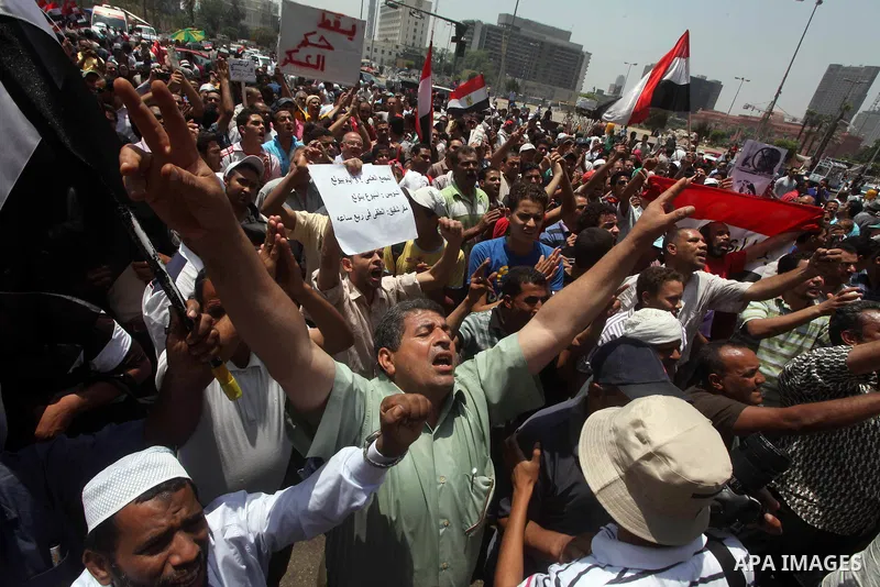 Egyptian protesters hold placards and shout slogans against the presidential candidate Ahmed Shafik, during a protest in Tahrir Square, Cairo, Egypt, 01 June 2012. Media reports state that hundreds of Egyptians held a de...
