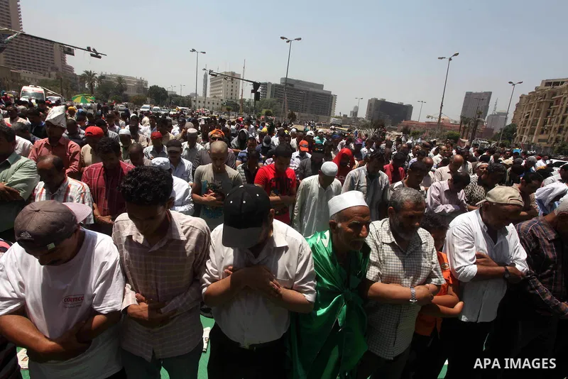 Egyptian protesters perform the weekly Friday noon prayer in Cairo's landmark Tahrir square during a demonstration against Egyptian presidential runoff candidate Ahmed Shafiq, an ex-prime minister under the ousted regime...