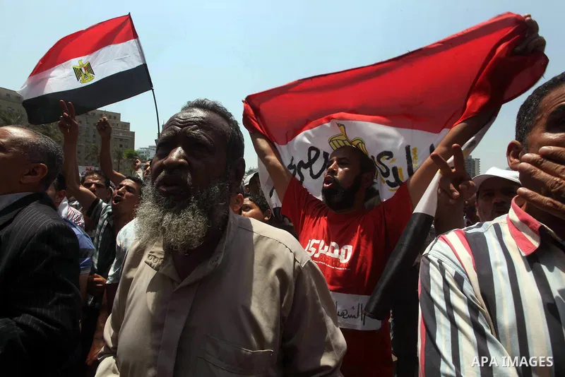 Egyptian protesters hold placards and shout slogans against the presidential candidate Ahmed Shafik, during a protest in Tahrir Square, Cairo, Egypt, 01 June 2012. Media reports state that hundreds of Egyptians held a de...