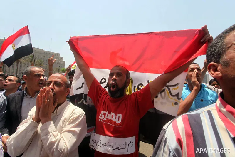 Egyptian protesters hold placards and shout slogans against the presidential candidate Ahmed Shafik, during a protest in Tahrir Square, Cairo, Egypt, 01 June 2012. Media reports state that hundreds of Egyptians held a de...