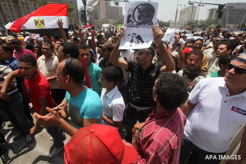 Egyptian protesters hold placards and shout slogans against the presidential candidate Ahmed Shafik, during a protest in Tahrir Square, Cairo, Egypt, 01 June 2012. Media reports state that hundreds of Egyptians held a de...