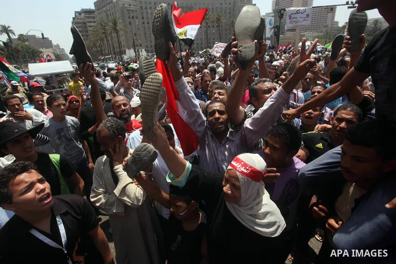 Egyptian protesters hold shoes and shout slogans against the presidential candidate Ahmed Shafik, during a protest in Tahrir Square, Cairo, Egypt, 01 June 2012. Media reports state that hundreds of Egyptians held a demon...