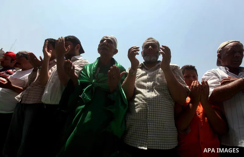 Egyptian protesters perform the weekly Friday noon prayer in Cairo's landmark Tahrir square during a demonstration against Egyptian presidential runoff candidate Ahmed Shafiq, an ex-prime minister under the ousted regime...