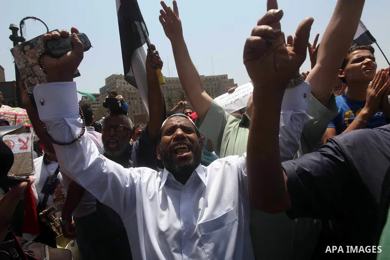 Egyptian protesters hold placards and shout slogans against the presidential candidate Ahmed Shafik, during a protest in Tahrir Square, Cairo, Egypt, 01 June 2012. Media reports state that hundreds of Egyptians held a de...