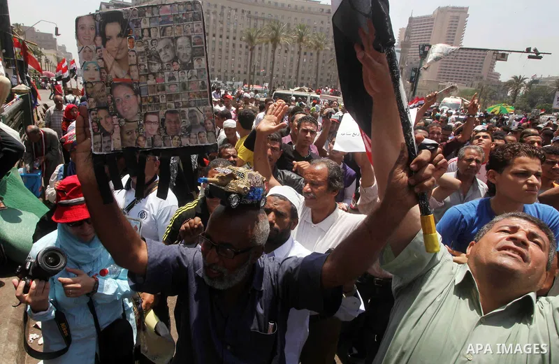 Egyptian protesters hold placards and shout slogans against the presidential candidate Ahmed Shafik, during a protest in Tahrir Square, Cairo, Egypt, 01 June 2012. Media reports state that hundreds of Egyptians held a de...