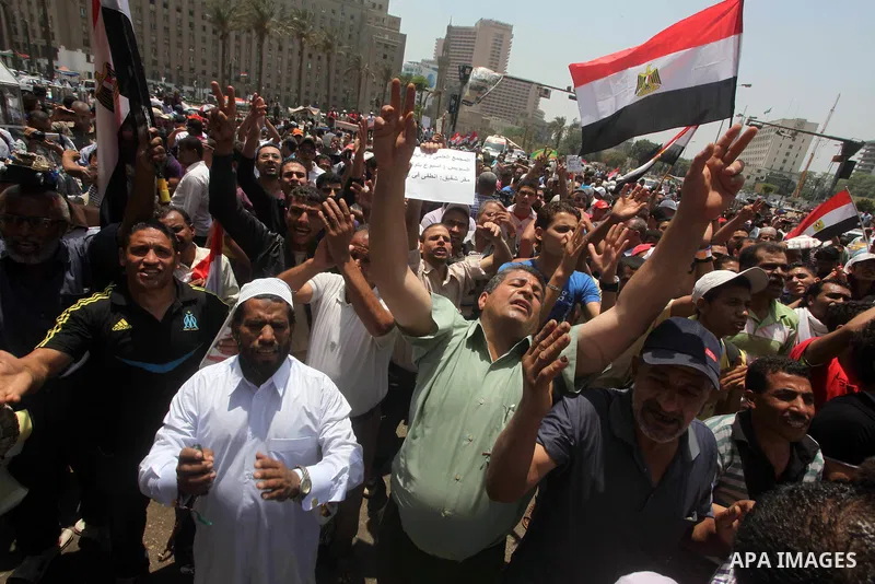 Egyptian protesters hold placards and shout slogans against the presidential candidate Ahmed Shafik, during a protest in Tahrir Square, Cairo, Egypt, 01 June 2012. Media reports state that hundreds of Egyptians held a de...
