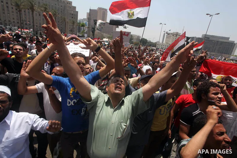 Egyptian protesters hold placards and shout slogans against the presidential candidate Ahmed Shafik, during a protest in Tahrir Square, Cairo, Egypt, 01 June 2012. Media reports state that hundreds of Egyptians held a de...