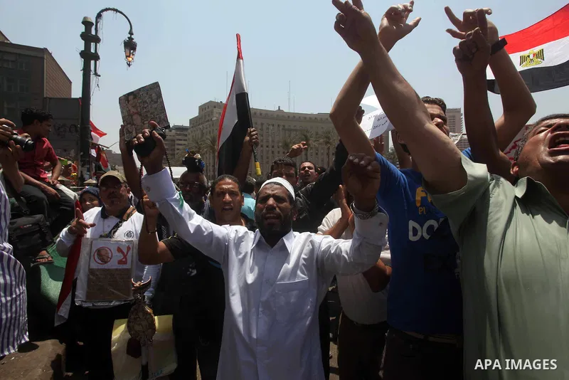 Egyptian protesters hold placards and shout slogans against the presidential candidate Ahmed Shafik, during a protest in Tahrir Square, Cairo, Egypt, 01 June 2012. Media reports state that hundreds of Egyptians held a de...