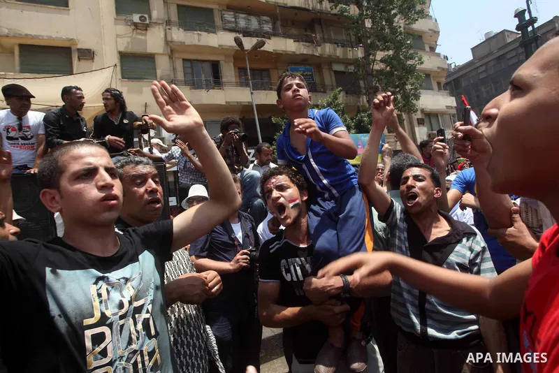 Egyptian protesters hold placards and shout slogans against the presidential candidate Ahmed Shafik, during a protest in Tahrir Square, Cairo, Egypt, 01 June 2012. Media reports state that hundreds of Egyptians held a de...
