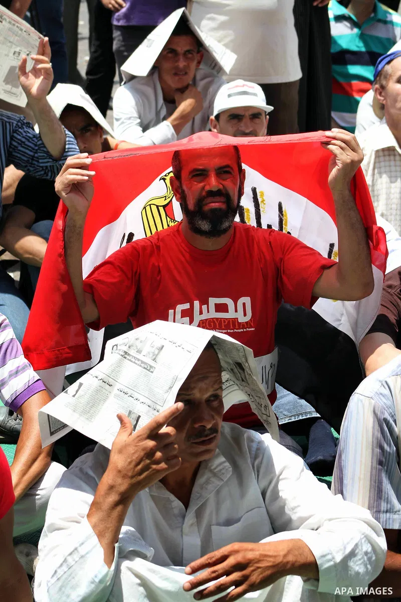 Egyptian protesters hold placards and shout slogans against the presidential candidate Ahmed Shafik, during a protest in Tahrir Square, Cairo, Egypt, 01 June 2012. Media reports state that hundreds of Egyptians held a de...