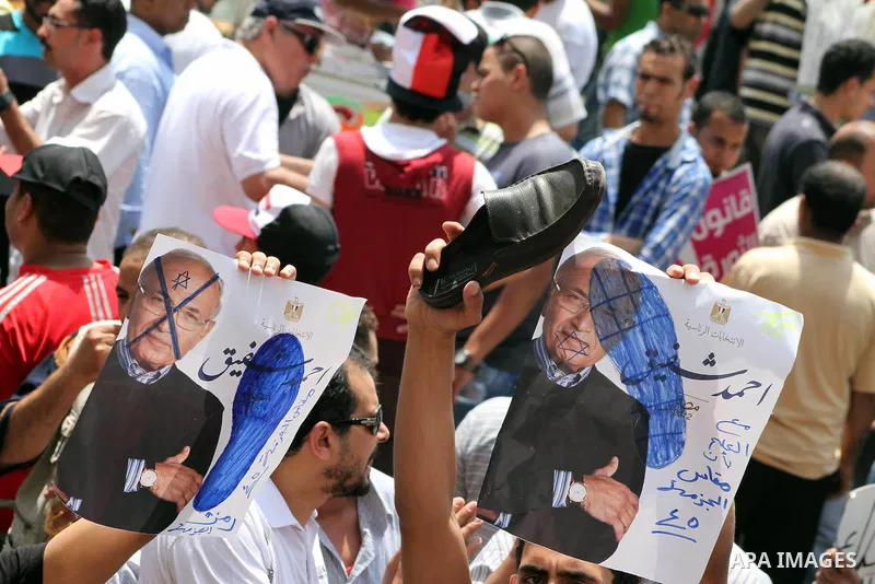 Egyptian protesters hold shoes and shout slogans against the presidential candidate Ahmed Shafik, during a protest in Tahrir Square, Cairo, Egypt, 01 June 2012. Media reports state that hundreds of Egyptians held a demon...