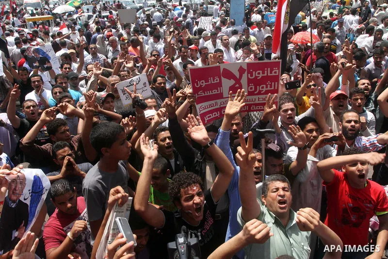 Egyptian protesters hold placards and shout slogans against the presidential candidate Ahmed Shafik, during a protest in Tahrir Square, Cairo, Egypt, 01 June 2012. Media reports state that hundreds of Egyptians held a de...