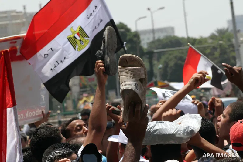 Egyptian protesters hold shoes and shout slogans against the presidential candidate Ahmed Shafik, during a protest in Tahrir Square, Cairo, Egypt, 01 June 2012. Media reports state that hundreds of Egyptians held a demon...