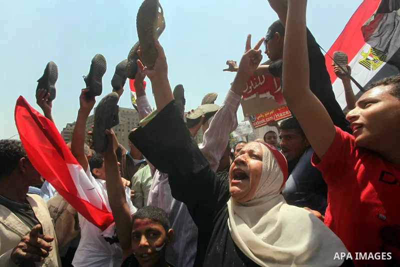 Egyptian protesters hold shoes and shout slogans against the presidential candidate Ahmed Shafik, during a protest in Tahrir Square, Cairo, Egypt, 01 June 2012. Media reports state that hundreds of Egyptians held a demon...