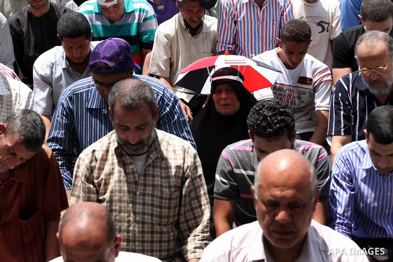 Egyptian protesters perform the weekly Friday noon prayer in Cairo's landmark Tahrir square during a demonstration against Egyptian presidential runoff candidate Ahmed Shafiq, an ex-prime minister under the ousted regime...
