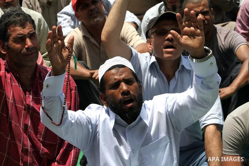 Egyptian protesters hold placards and shout slogans against the presidential candidate Ahmed Shafik, during a protest in Tahrir Square, Cairo, Egypt, 01 June 2012. Media reports state that hundreds of Egyptians held a de...