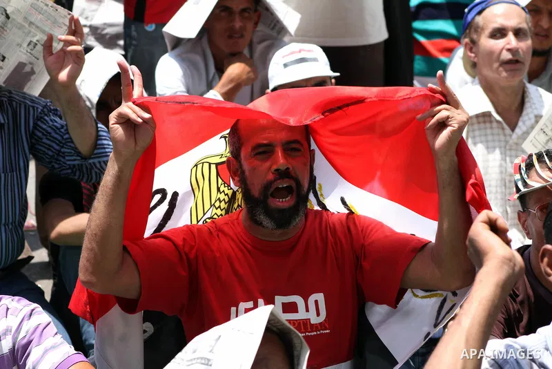 Egyptian protesters hold placards and shout slogans against the presidential candidate Ahmed Shafik, during a protest in Tahrir Square, Cairo, Egypt, 01 June 2012. Media reports state that hundreds of Egyptians held a de...