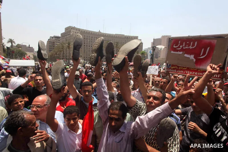 Egyptian protesters hold shoes and shout slogans against the presidential candidate Ahmed Shafik, during a protest in Tahrir Square, Cairo, Egypt, 01 June 2012. Media reports state that hundreds of Egyptians held a demon...