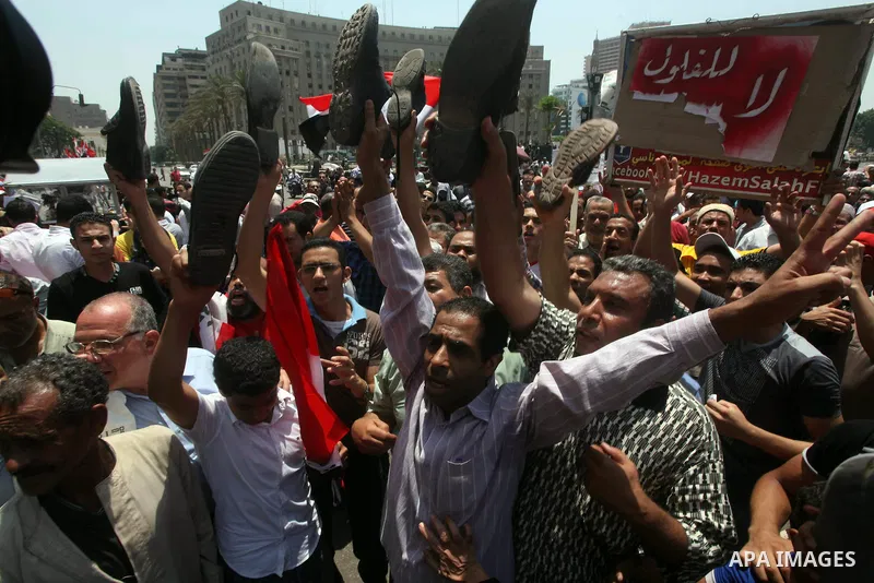 Egyptian protesters hold shoes and shout slogans against the presidential candidate Ahmed Shafik, during a protest in Tahrir Square, Cairo, Egypt, 01 June 2012. Media reports state that hundreds of Egyptians held a demon...