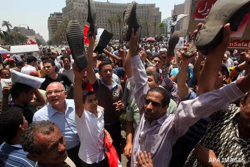 Egyptian protesters hold shoes and shout slogans against the presidential candidate Ahmed Shafik, during a protest in Tahrir Square, Cairo, Egypt, 01 June 2012. Media reports state that hundreds of Egyptians held a demon...