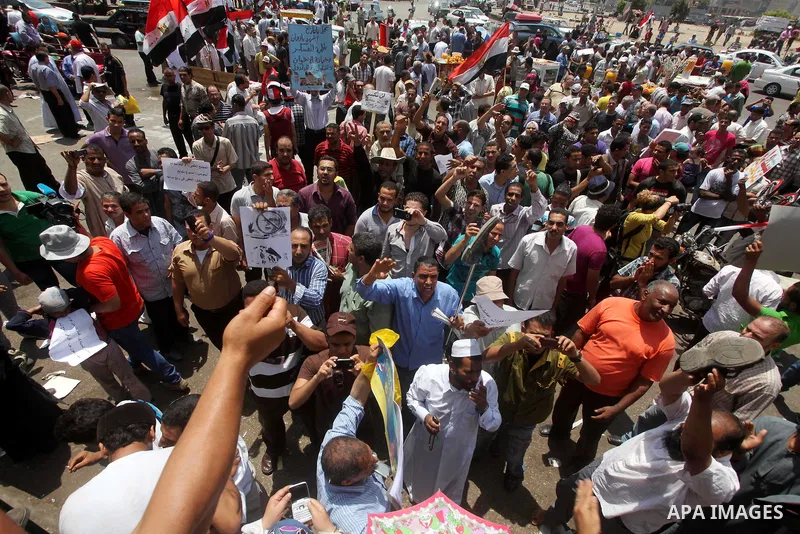 Egyptian protesters hold placards and shout slogans against the presidential candidate Ahmed Shafik, during a protest in Tahrir Square, Cairo, Egypt, 01 June 2012. Media reports state that hundreds of Egyptians held a de...