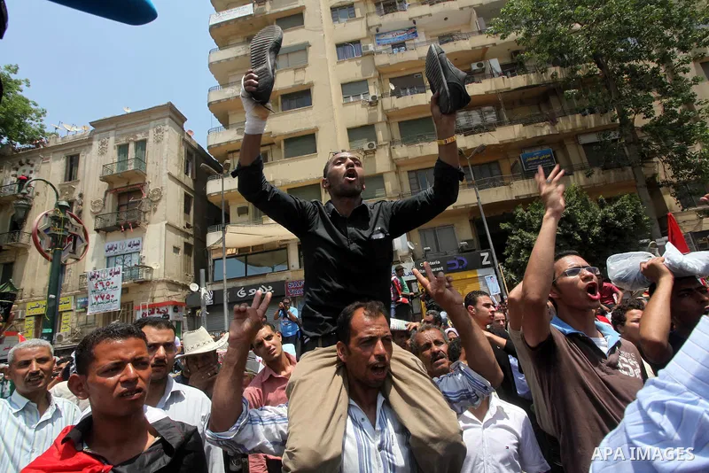 Egyptian protesters hold shoes and shout slogans against the presidential candidate Ahmed Shafik, during a protest in Tahrir Square, Cairo, Egypt, 01 June 2012. Media reports state that hundreds of Egyptians held a demon...