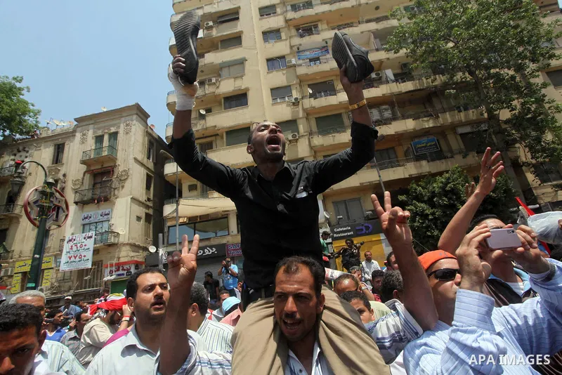 Egyptian protesters hold shoes and shout slogans against the presidential candidate Ahmed Shafik, during a protest in Tahrir Square, Cairo, Egypt, 01 June 2012. Media reports state that hundreds of Egyptians held a demon...