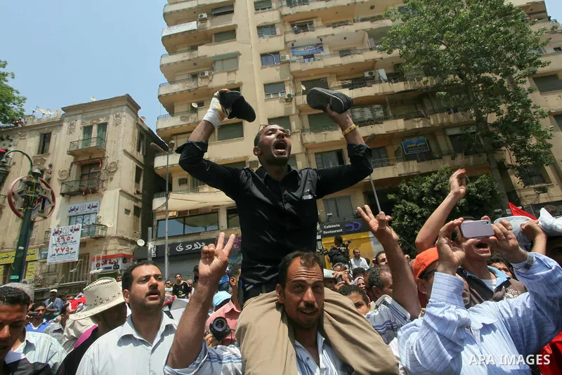 Egyptian protesters hold shoes and shout slogans against the presidential candidate Ahmed Shafik, during a protest in Tahrir Square, Cairo, Egypt, 01 June 2012. Media reports state that hundreds of Egyptians held a demon...