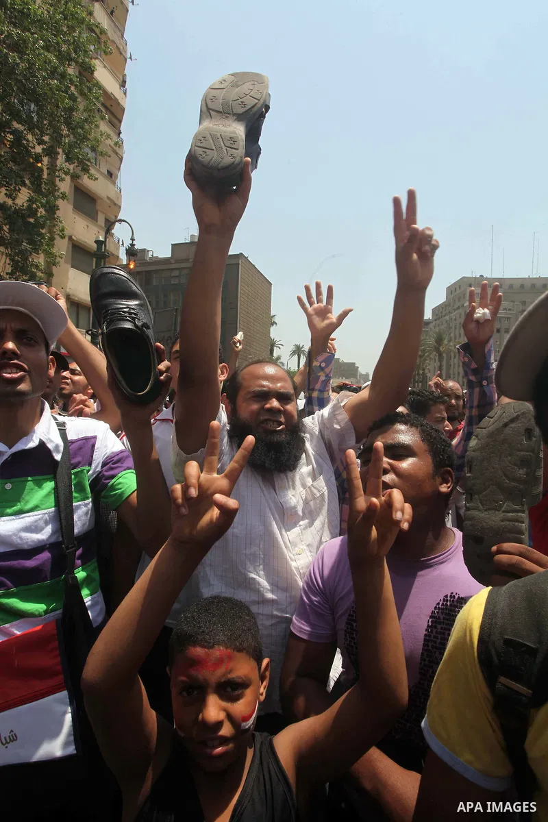 Egyptian protesters hold shoes and shout slogans against the presidential candidate Ahmed Shafik, during a protest in Tahrir Square, Cairo, Egypt, 01 June 2012. Media reports state that hundreds of Egyptians held a demon...