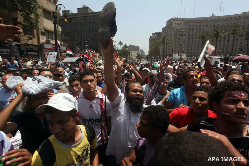 Egyptian protesters hold shoes and shout slogans against the presidential candidate Ahmed Shafik, during a protest in Tahrir Square, Cairo, Egypt, 01 June 2012. Media reports state that hundreds of Egyptians held a demon...