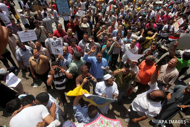 Egyptian protesters hold placards and shout slogans against the presidential candidate Ahmed Shafik, during a protest in Tahrir Square, Cairo, Egypt, 01 June 2012. Media reports state that hundreds of Egyptians held a de...