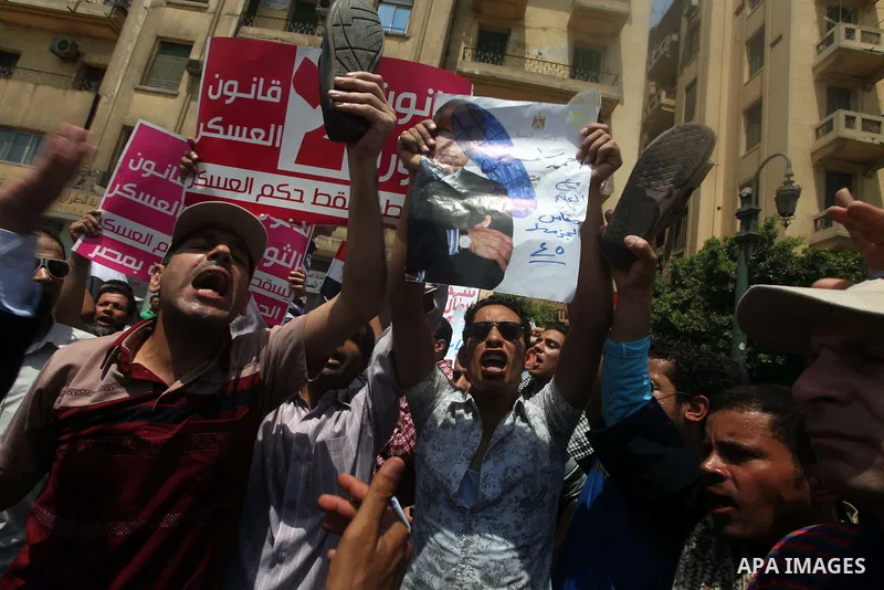 Egyptian protesters hold shoes and shout slogans against the presidential candidate Ahmed Shafik, during a protest in Tahrir Square, Cairo, Egypt, 01 June 2012. Media reports state that hundreds of Egyptians held a demon...