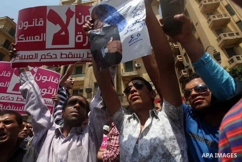 Egyptian protesters hold shoes and shout slogans against the presidential candidate Ahmed Shafik, during a protest in Tahrir Square, Cairo, Egypt, 01 June 2012. Media reports state that hundreds of Egyptians held a demon...