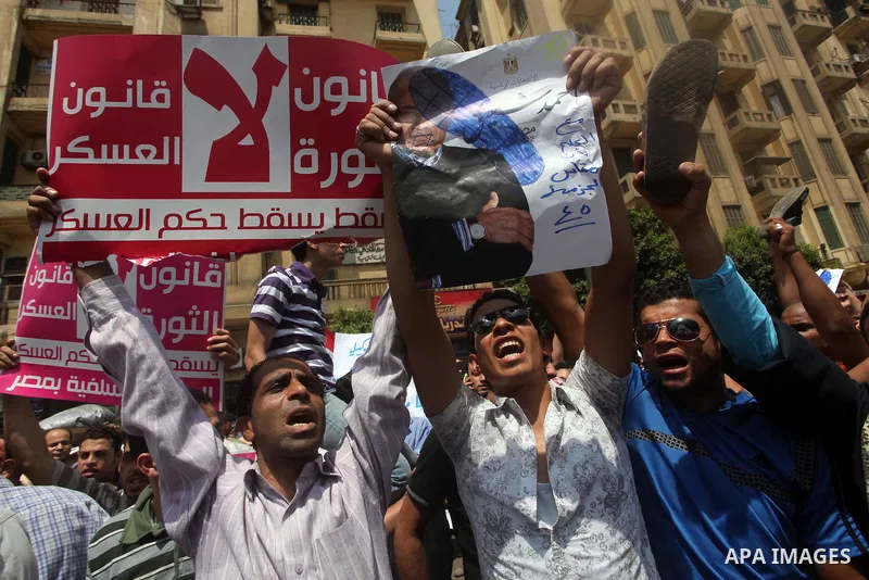 Egyptian protesters hold placards and shout slogans against the presidential candidate Ahmed Shafik, during a protest in Tahrir Square, Cairo, Egypt, 01 June 2012. Media reports state that hundreds of Egyptians held a de...