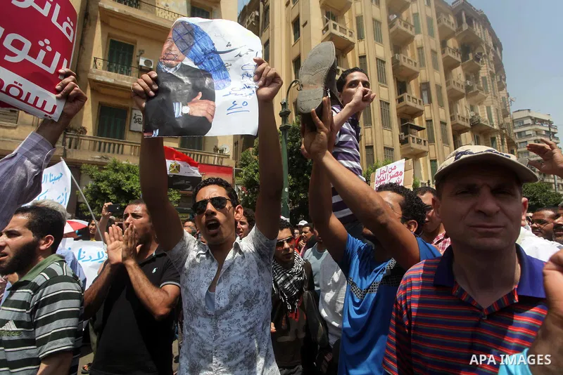 Egyptian protesters hold shoes and shout slogans against the presidential candidate Ahmed Shafik, during a protest in Tahrir Square, Cairo, Egypt, 01 June 2012. Media reports state that hundreds of Egyptians held a demon...