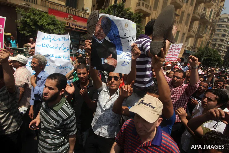 Egyptian protesters hold shoes and shout slogans against the presidential candidate Ahmed Shafik, during a protest in Tahrir Square, Cairo, Egypt, 01 June 2012. Media reports state that hundreds of Egyptians held a demon...