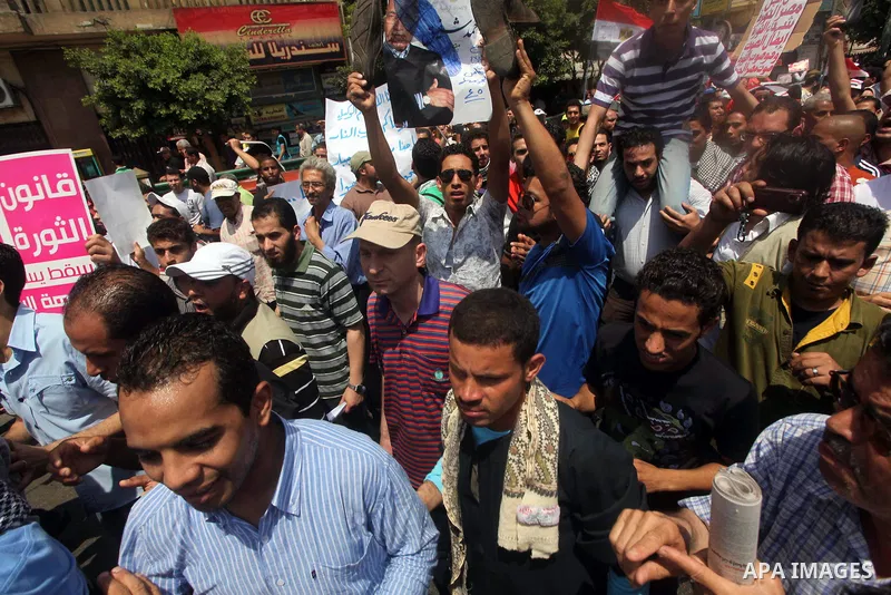 Egyptian protesters hold placards and shout slogans against the presidential candidate Ahmed Shafik, during a protest in Tahrir Square, Cairo, Egypt, 01 June 2012. Media reports state that hundreds of Egyptians held a de...