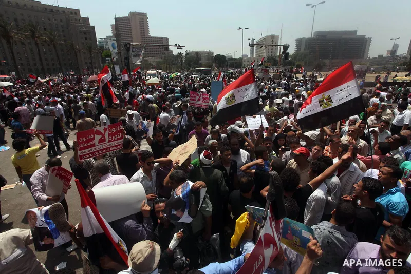 Egyptian protesters hold placards and shout slogans against the presidential candidate Ahmed Shafik, during a protest in Tahrir Square, Cairo, Egypt, 01 June 2012. Media reports state that hundreds of Egyptians held a de...