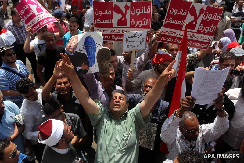 Egyptian protesters hold placards and shout slogans against the presidential candidate Ahmed Shafik, during a protest in Tahrir Square, Cairo, Egypt, 01 June 2012. Media reports state that hundreds of Egyptians held a de...