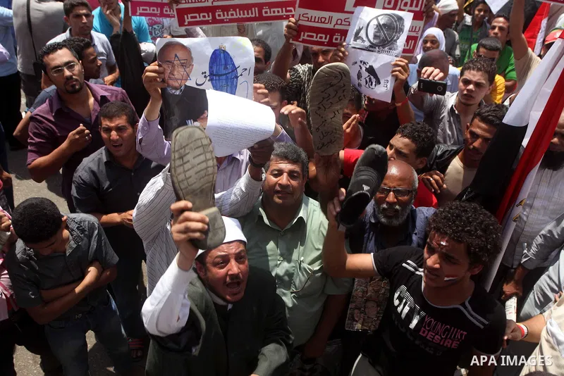 Egyptian protesters hold shoes and shout slogans against the presidential candidate Ahmed Shafik, during a protest in Tahrir Square, Cairo, Egypt, 01 June 2012. Media reports state that hundreds of Egyptians held a demon...