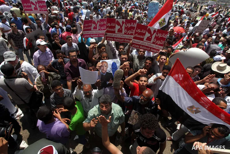Egyptian protesters hold placards and shout slogans against the presidential candidate Ahmed Shafik, during a protest in Tahrir Square, Cairo, Egypt, 01 June 2012. Media reports state that hundreds of Egyptians held a de...