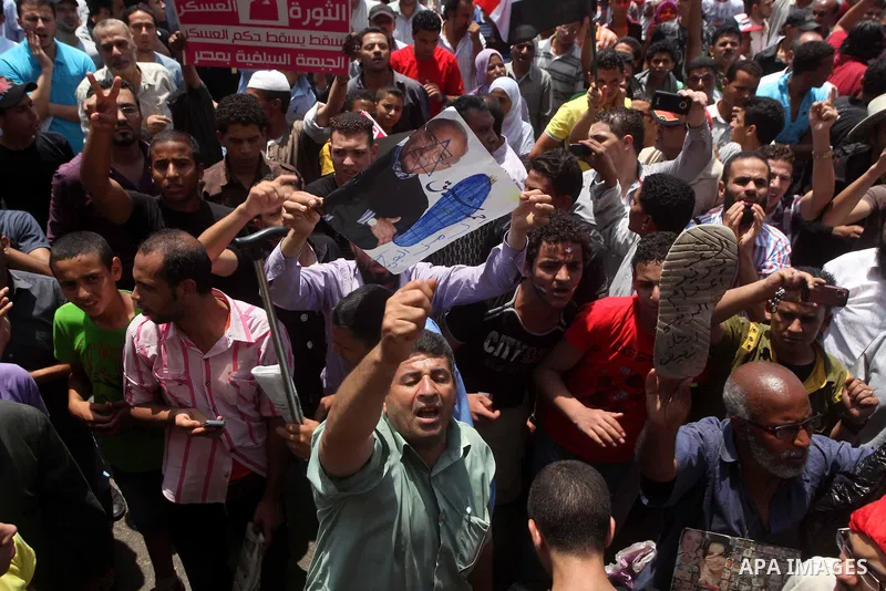 Egyptian protesters hold placards and shout slogans against the presidential candidate Ahmed Shafik, during a protest in Tahrir Square, Cairo, Egypt, 01 June 2012. Media reports state that hundreds of Egyptians held a de...