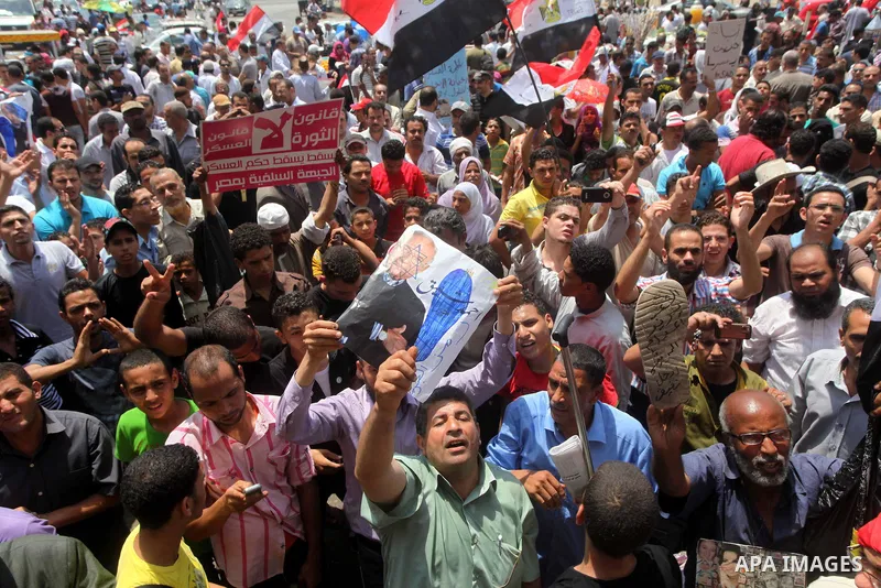 Egyptian protesters hold placards and shout slogans against the presidential candidate Ahmed Shafik, during a protest in Tahrir Square, Cairo, Egypt, 01 June 2012. Media reports state that hundreds of Egyptians held a de...