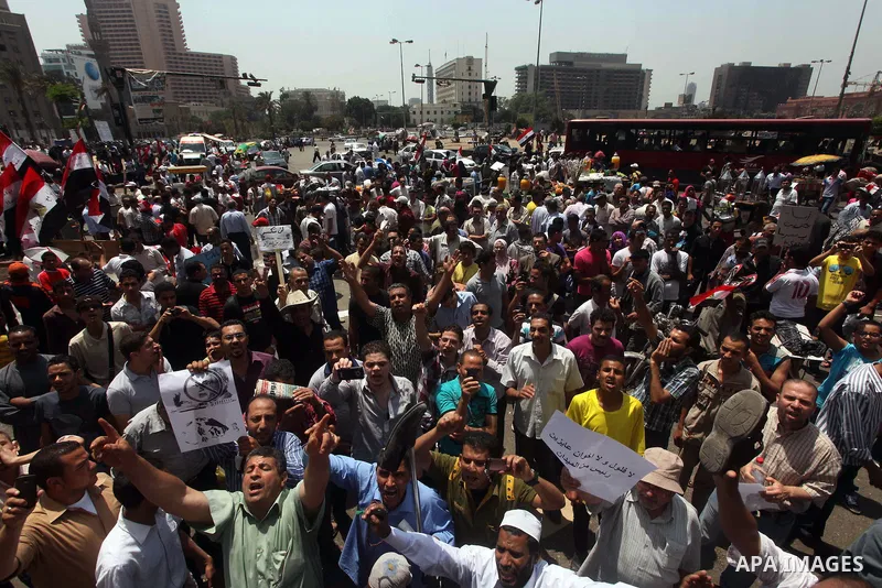 Egyptian protesters hold placards and shout slogans against the presidential candidate Ahmed Shafik, during a protest in Tahrir Square, Cairo, Egypt, 01 June 2012. Media reports state that hundreds of Egyptians held a de...
